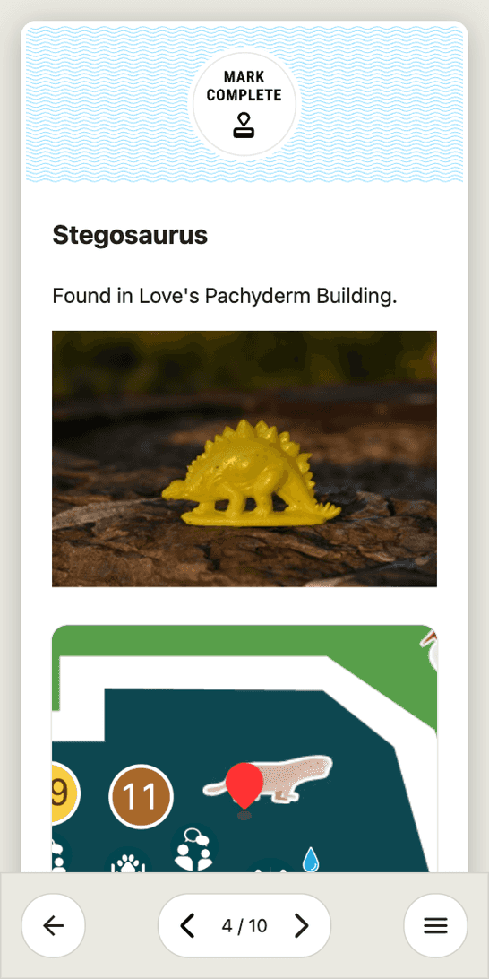 The Stegosaurus entry, marked COMPLETE, with a photo of the molded figure, the building it is found in, and a detail map pinning the machine.